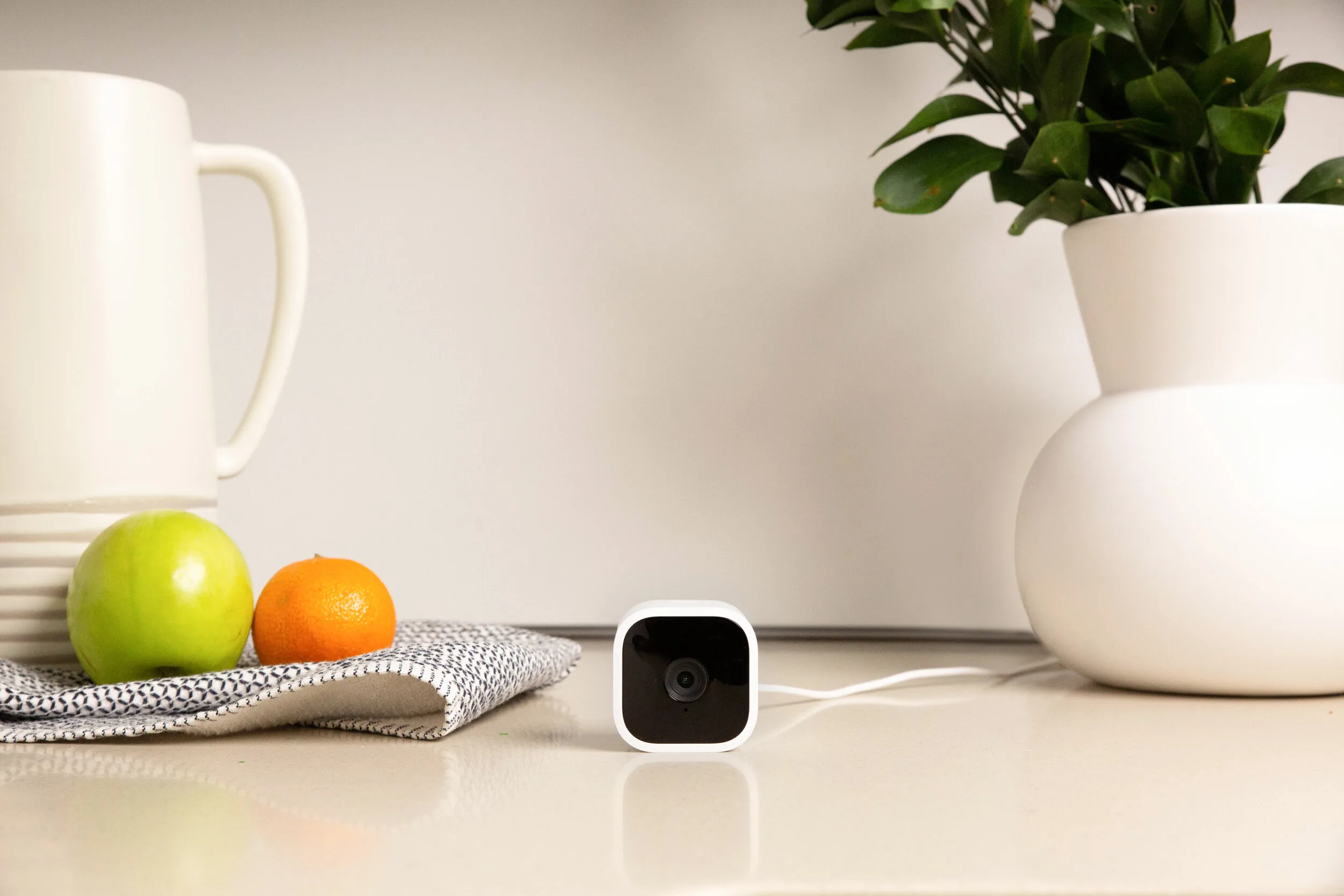 White Blink Mini plug-in indoor security camera on its adjustable stand